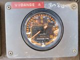 a close up of a gauge on a metal panel