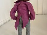 a figurine of a man wearing a hat and a purple coat