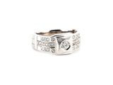 a close up of a ring on a white surface with diamonds