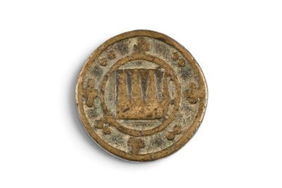 an old coin with a roman numeral on it on a white surface
