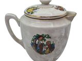 a white teapot with a picture of a boy and a dog on it
