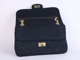 the back of a black backpack with gold hardware on it