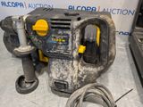 an image of a power drill sitting on top of a table next to a cord