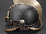 an old helmet with a leather band and a metal buckle