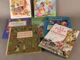 several children ' s books are lined up on a table
