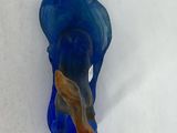 a blue elephant that is standing in the snow