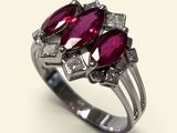 an image of a close up of a ring with two ruby stones