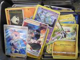 a lot of pokemon cards in a plastic container