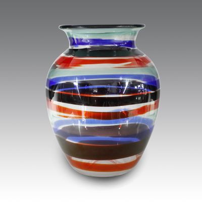 a colorful glass vase that is sitting on a table