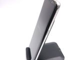 a cell phone that is sitting on top of a stand