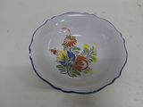 a small bowl with a flower design on it