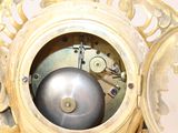 a gold clock with a silver ball in the middle of it