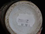 a close up of a white vase with a label on it