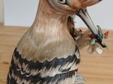 a bird that is sitting on top of a wooden table