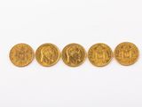 cinq souverains d'or alignés sur un fond blanc