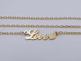 a gold plated necklace with the word love on it