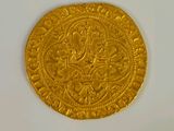 an image of a gold coin sitting on top of a white surface