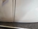 a close up of a white microwave on a counter