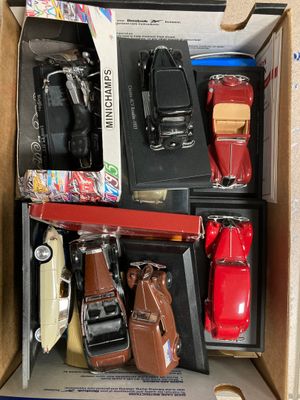 a lot of toy cars in a box on the floor