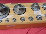 a wooden device with buttons on it sitting on a red surface