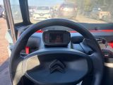 the steering wheel of a red and black vehicle with a gps device on it