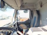 a view of the inside of a truck from the driver ' s seat