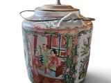a vase with a lid that has a picture of a woman on it