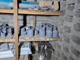 a room with shelves filled with pots and pans