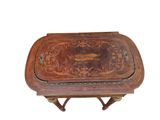 an old wooden table with a decorative design on the top of it