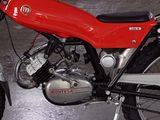 a red motorcycle that is parked in a garage