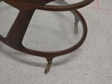 a glass table with a wooden base and a glass top