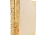 an old book sitting on top of a table next to a white background