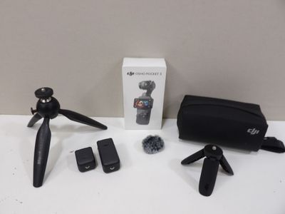 a camera and a tripod sitting on a table next to a box