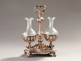 an antique silver plated three - light candle holder with two glass vases