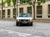 a car that is driving down the street in front of a building