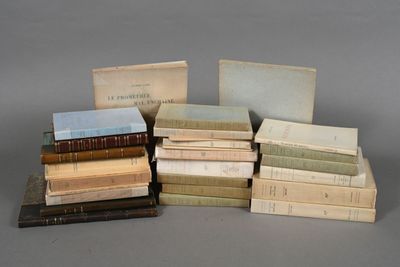 several old books stacked on top of each other on a table