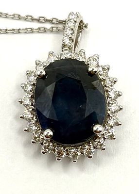 an image of a blue sapphire and diamond pendant on a chain