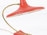 an image of a red desk lamp with a gold base and a red shade