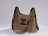 a brown and black handbag with a black logo on it