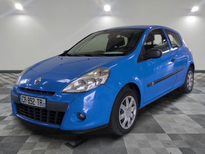 the small blue car is parked in a large room