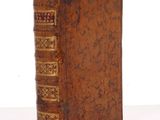 an old book sitting on top of a table next to a white background