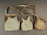 three old purses sitting on top of a table next to each other
