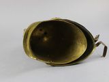 an old brass bell on a white surface with a white background