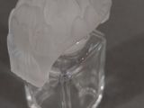 a glass vase with a flower in it on a table