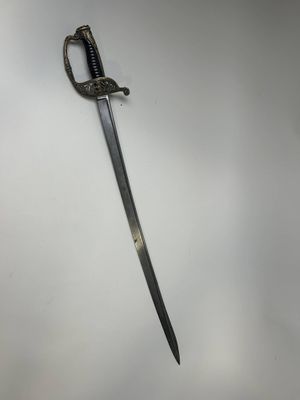 a close up of a sword on a wall with a white background