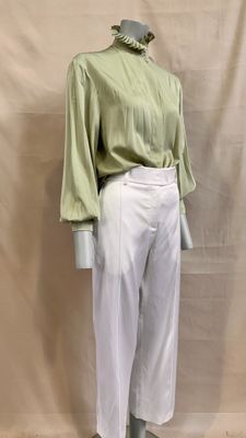 an image of a mannequin wearing a green shirt and white pants
