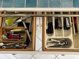 a drawer full of utensils and other kitchen utensils