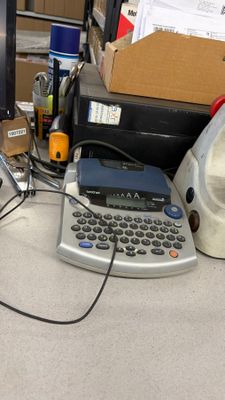 a typewriter sitting on a desk next to a computer monitor