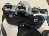 a camera with a strap on it sitting on a table