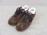 pair of brown sneakers with black laces on a white surface